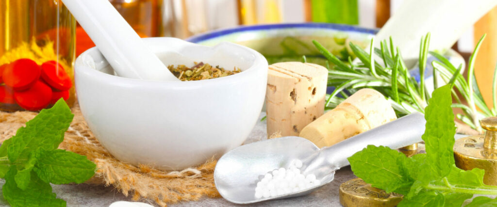Natural herbs and remedies beside a mortar and pestle