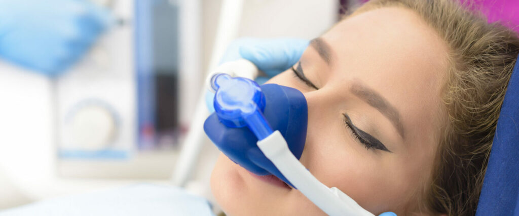Relaxed patient breathing nitrous oxide through a nasal mask