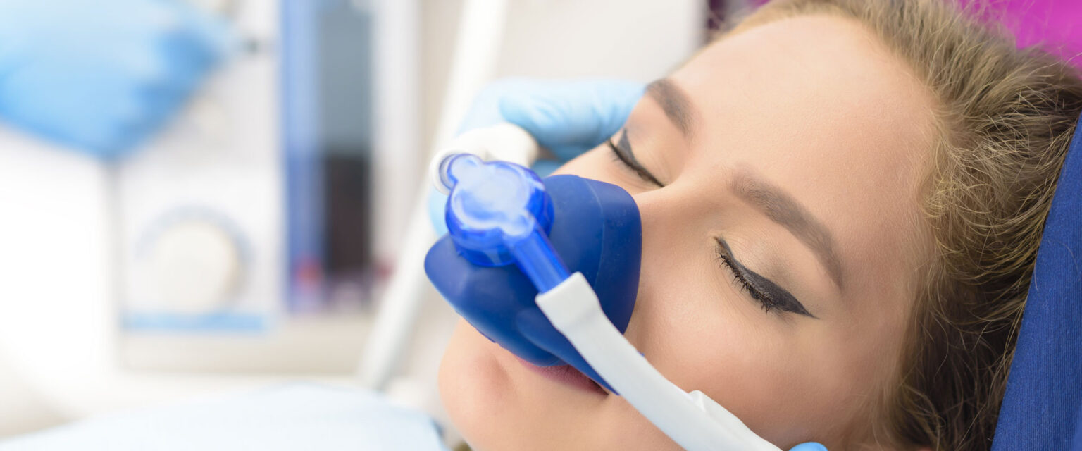 A patient resting comfortably in the chair during a gentle implant procedure