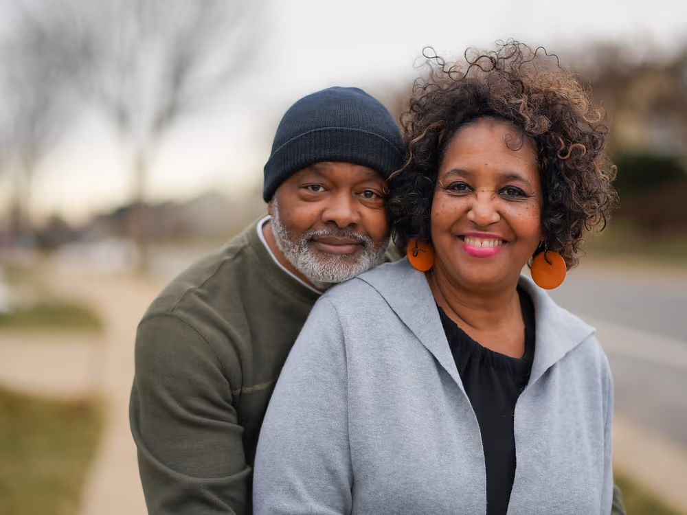 A couple smiling together, restored comfort and confidence after dental implants