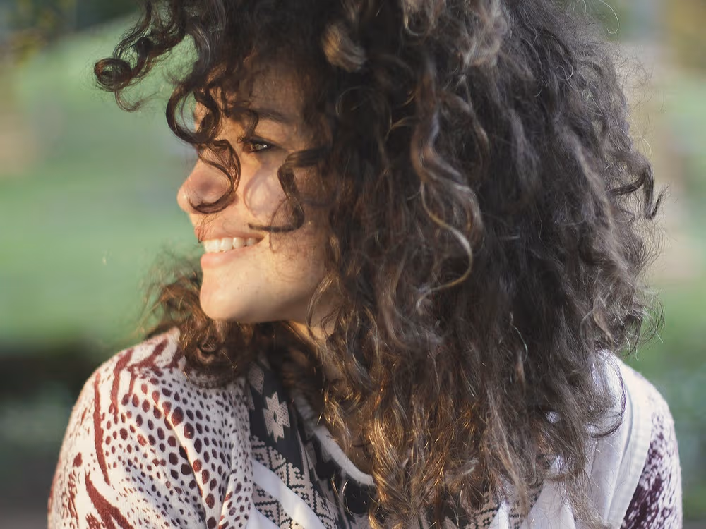 A woman smiling, at ease and feeling well