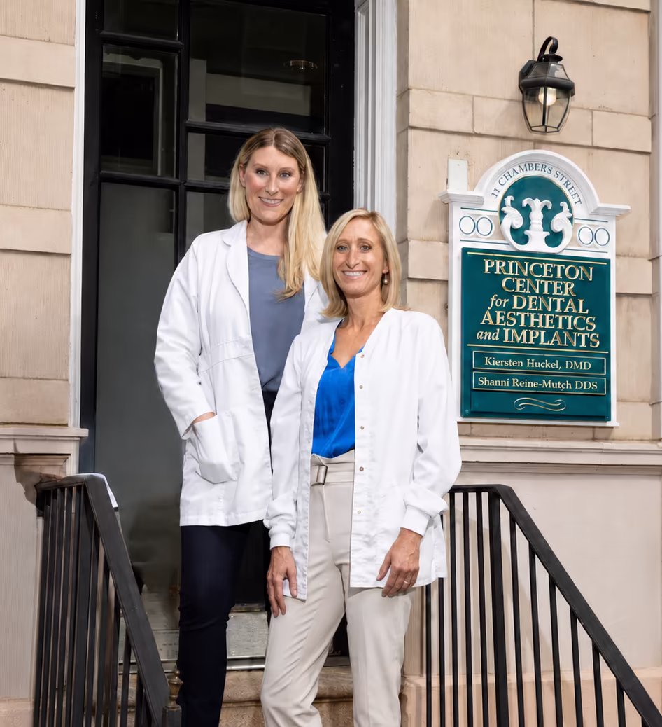 Dr. Kiersten Huckel and Dr. Shanni Reine-Mutch at the entrance to Princeton Center for Dental Aesthetics & Implants